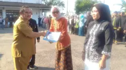 Asda Bidang Pamkesra, Dr. Dian Sukmara memberikan penghargaan pada upacara Peringatan Harganas 2026
